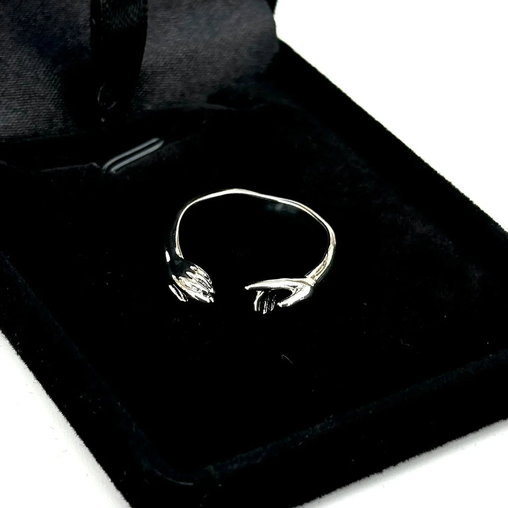 Black bag with a white embroidered design on a white background