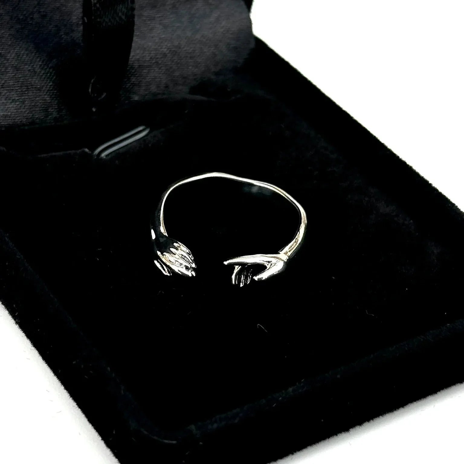 Black bag with a white embroidered design on a white background