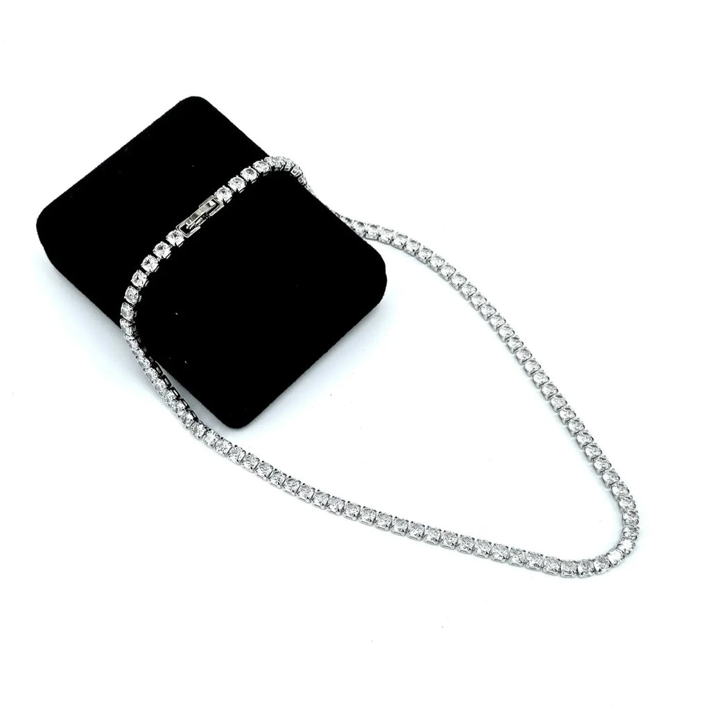 Black clutch bag with a silver chain on a white background