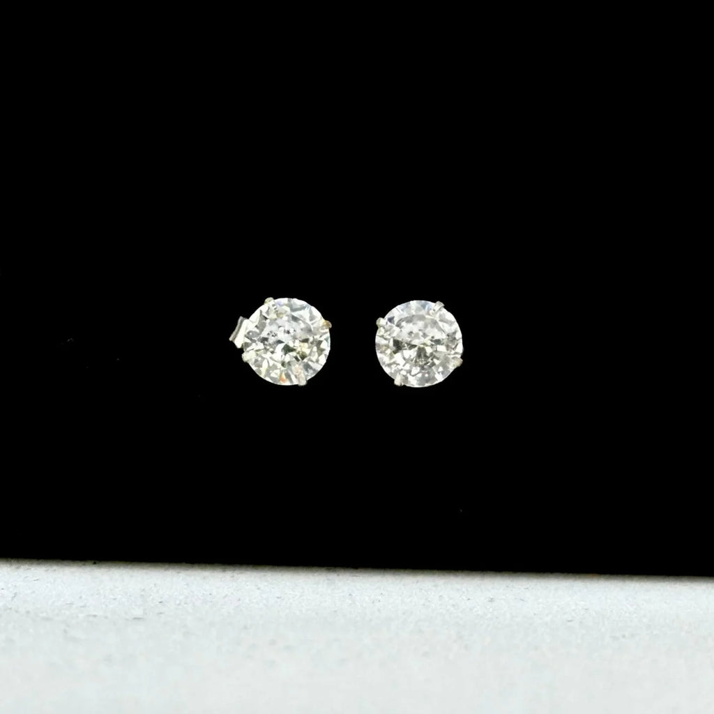 Diamond stud earrings on a black background