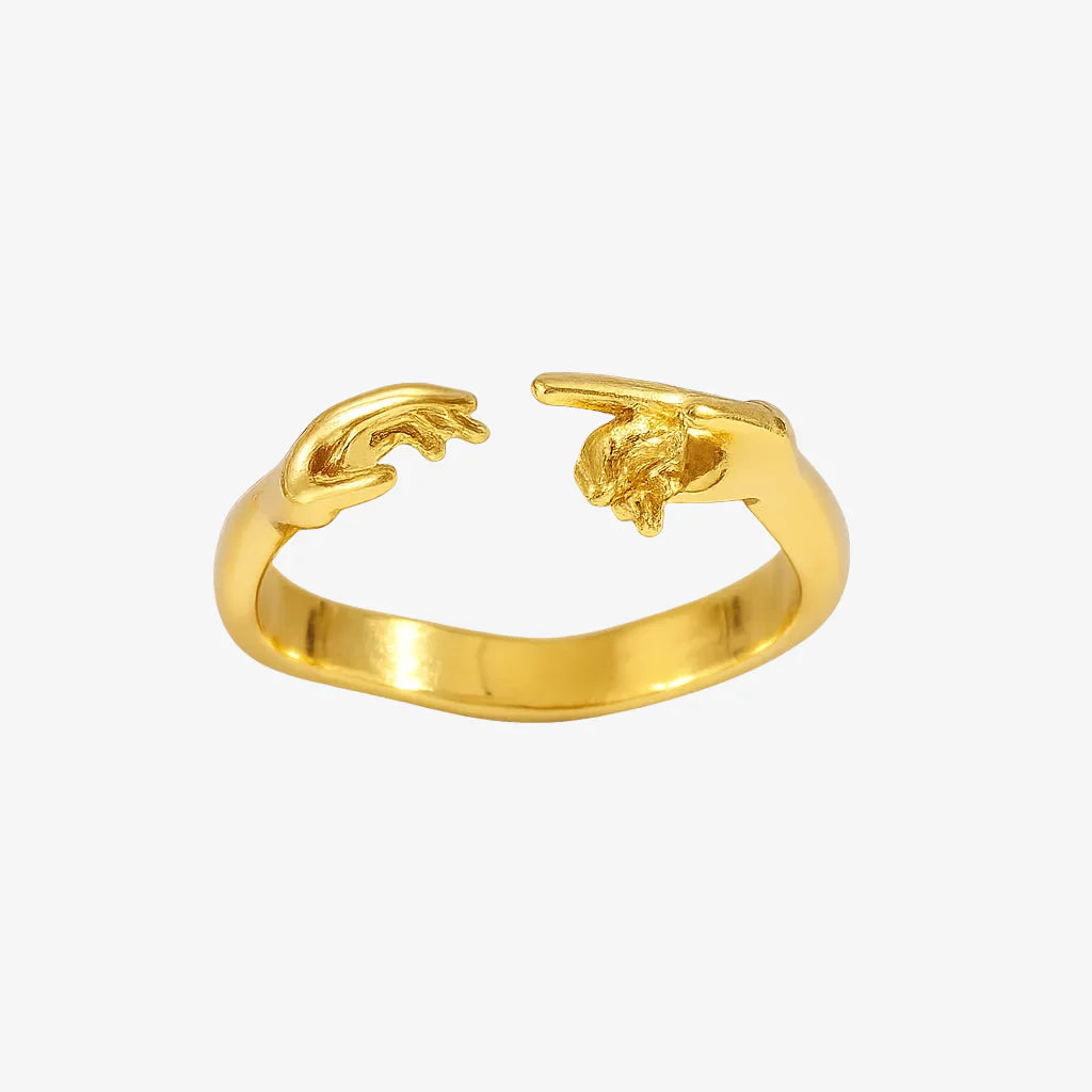 Gold ring with a lion head design on a white background