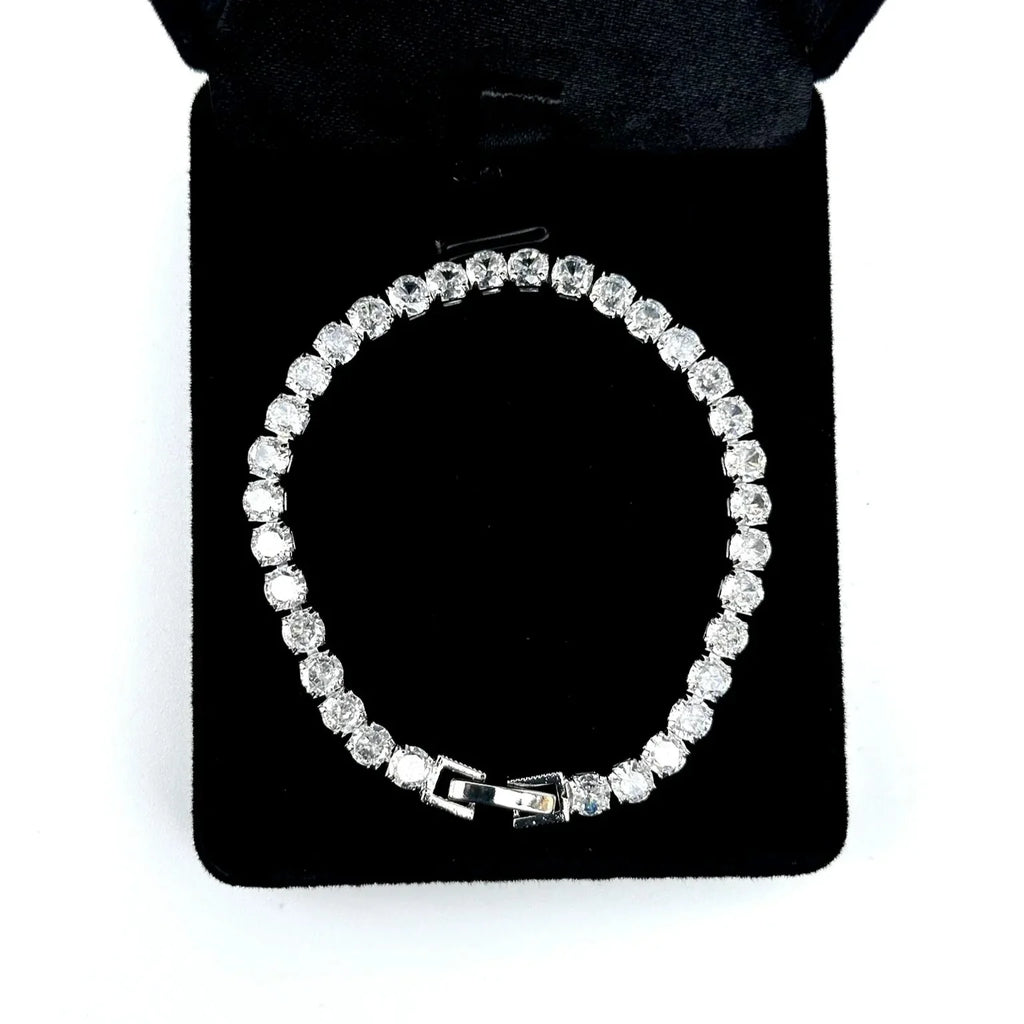 Silver bracelet on a black display box with a white background