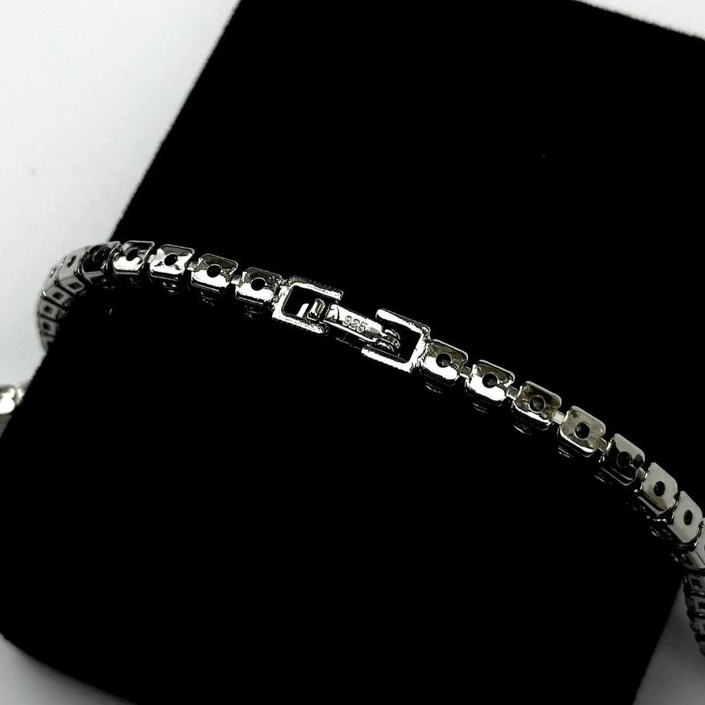 Silver bracelet on a black surface