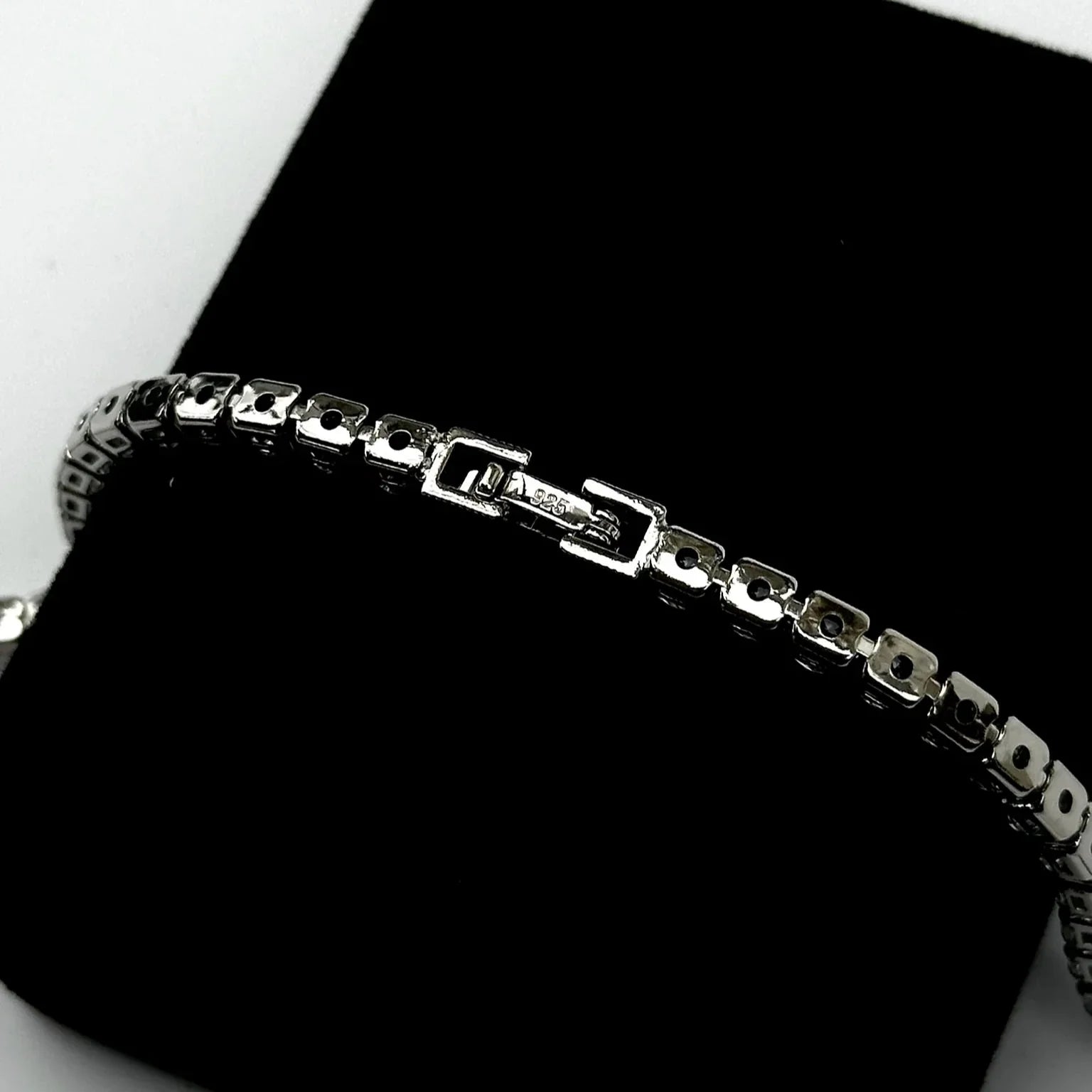 Silver bracelet on a black surface