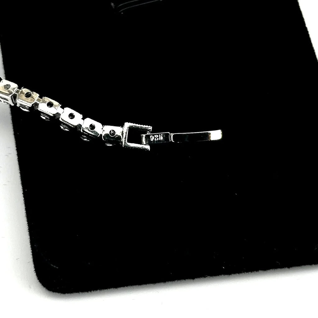 Silver bracelet on a black surface