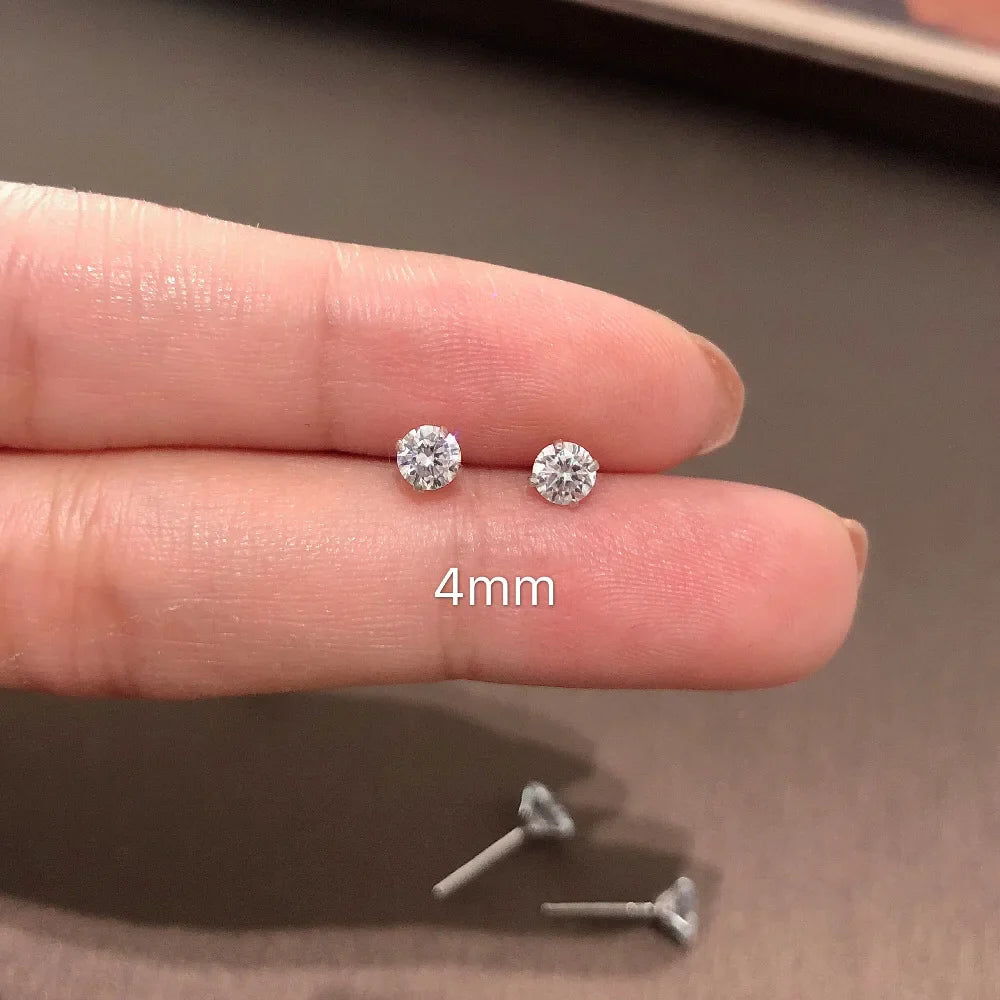Two silver stud earrings on a finger with '4mm' text, showing size comparison.
