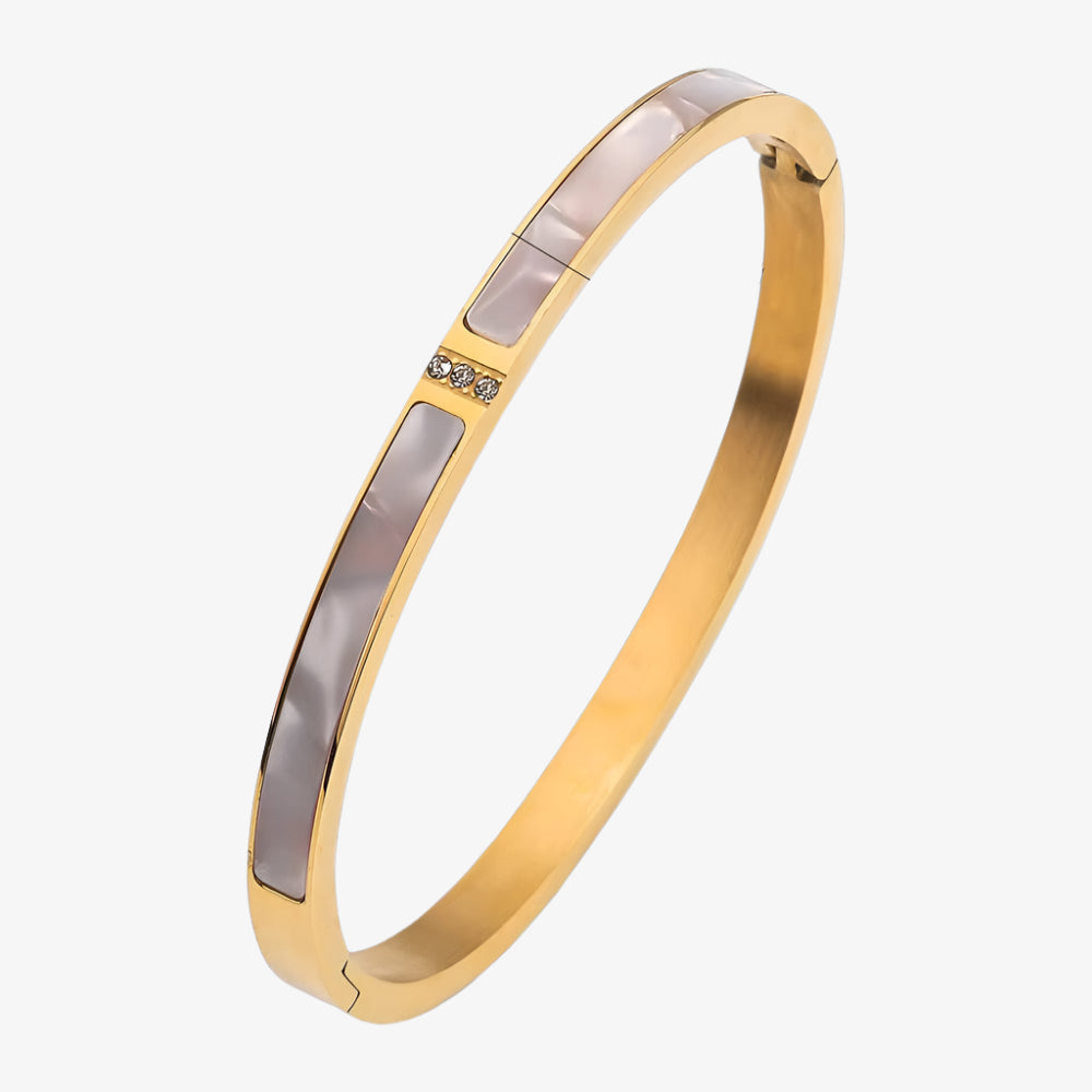 Gold bangle with measurements on a white background